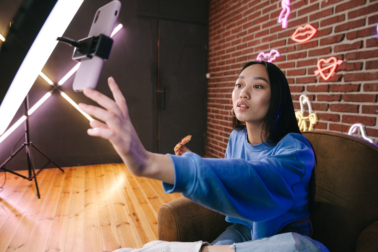 Crafting Captivating Headlines: Your awesome post title goes here Asian woman creates live stream content in stylish neon lit room.