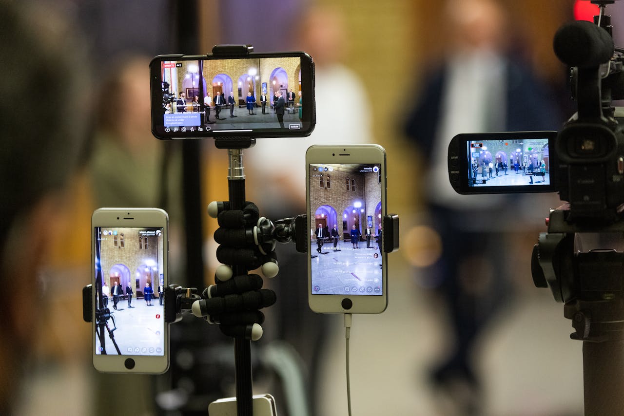 Mastering the First Impression: Your intriguing post title goes here Multiple mobile phones capturing a live event at a prominent landmark in Oslo, Norway.